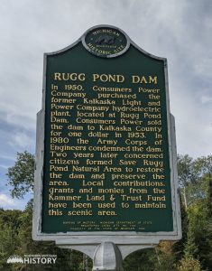 Back of Rugg Pond Dam Historical Marker