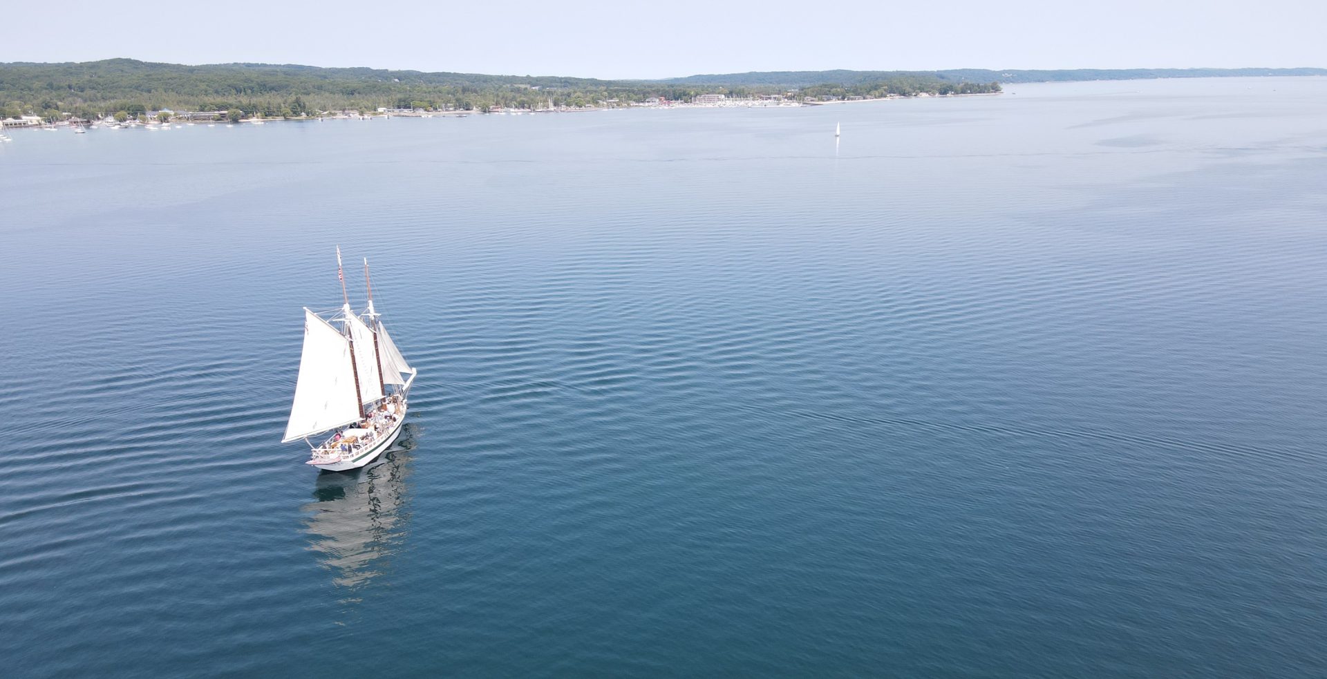 Aerial View White Sailboat in West Grand Traverse Bay, Traverse City in Northern Michigan