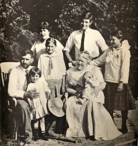 The Hemingway family at their cabin in Michigan. Standing rear, left to right, Marcelline, Sunny, Ernest and Ursula. Seated: Dr. Hemingway with Carol, Grace holding baby Leicester