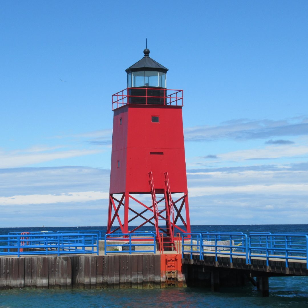 Discover the story behind the Charlevoix South Pier Light—its early north pier origins, 1948 rebuild, color changes, and role in guiding vessels today.