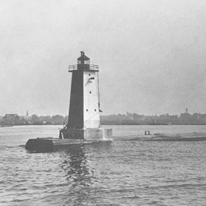 Manistique East Breakwater Light guided ships into a busy Lake Michigan harbor, reflecting the city’s industrial past and evolving maritime navigation.
