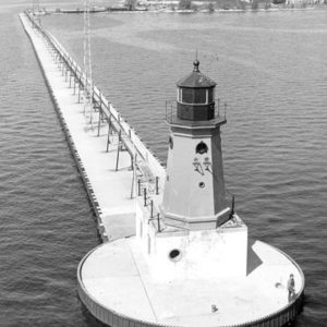 Discover the history of the Menominee North Pier Lighthouse, a bright red cast iron beacon that has guided Great Lakes ships since 1877.